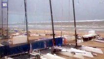 Dramatic moment seven foot tidal wave sweeps away beach chairs, boats and parasols as mini tsunami strikes the Netherlan