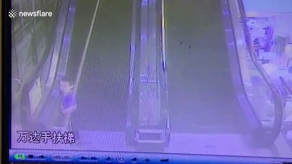 Boy's arm gets sucked into escalator in China