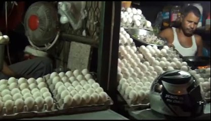 The man cooks the fried egg and gives it to the customer on the sandwich great