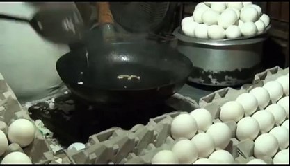 The man cooks the fried egg and gives it to the customer on the sandwich great amazing