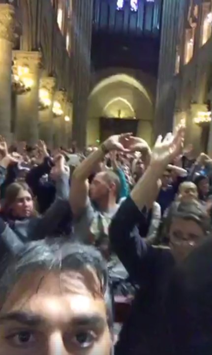 Tourists Hold Hands in Air During Lockdown Inside Notre Dame Cathedral