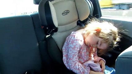 Two funny heavy headed girls falling asleep in car.