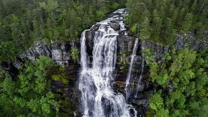 aerial-footage-from-tvindefossen-waterfall-from-the-birds-eye-view-norway_nj1dv49yx__PM