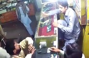 CCTV footage of mobile shop being robbed