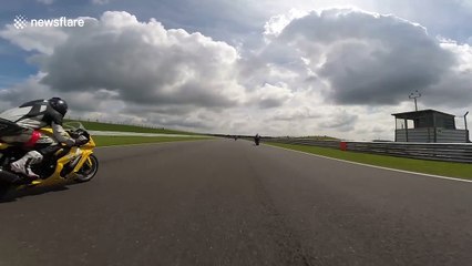 Motorcyclist crashes after being knocked out by flying debris