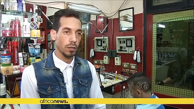 This African barber uses fire to cut and style his clients' hair