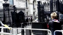 People protest outside Downing street as Theresa May leaves to meet the Queen