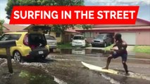 Surfing in the street: People in South Florida takes advantage of flooded neighborhood