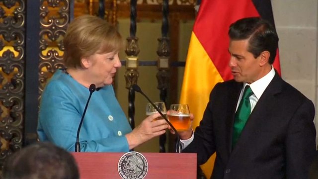 Angela Merkel pictured enjoying a drink as she urges May to get on with Brexit negotiations