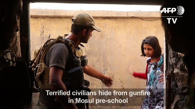 Terrified civilians hide from gunfire in Mosul pre-school