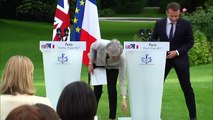 Theresa May loses papers during presser with Emmanuel Macron