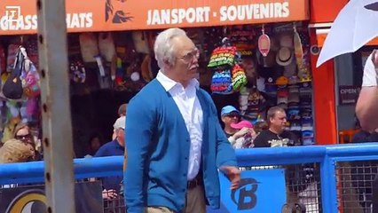 Bodybuilder disguised as old man pumps up the crowd