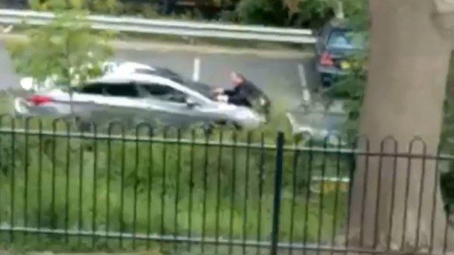 Man wanted for assault after driving away with police officer on his bonnet