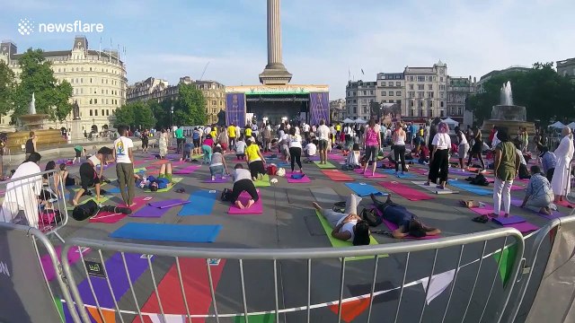 Londoners practise yoga on Trafalgar Square for international yoga day