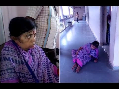 handicapped woman crawls on floor to reach taluk office for adharcard