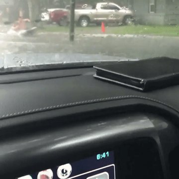 Two Men Kayak Through Streets Flooded by Tropical Storm Cindy