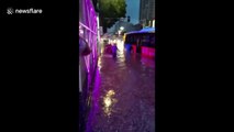 Hero bus driver helps passengers off bus stuck on flooded street