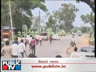 Yamanur people with sticks in hand follow police jeeps to stop them entering the village