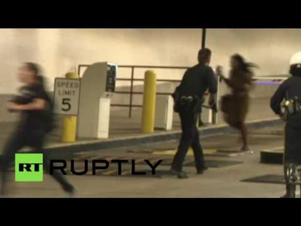 Police and Black Lives Matter activists run for cover amidst sniper fire in Dallas
