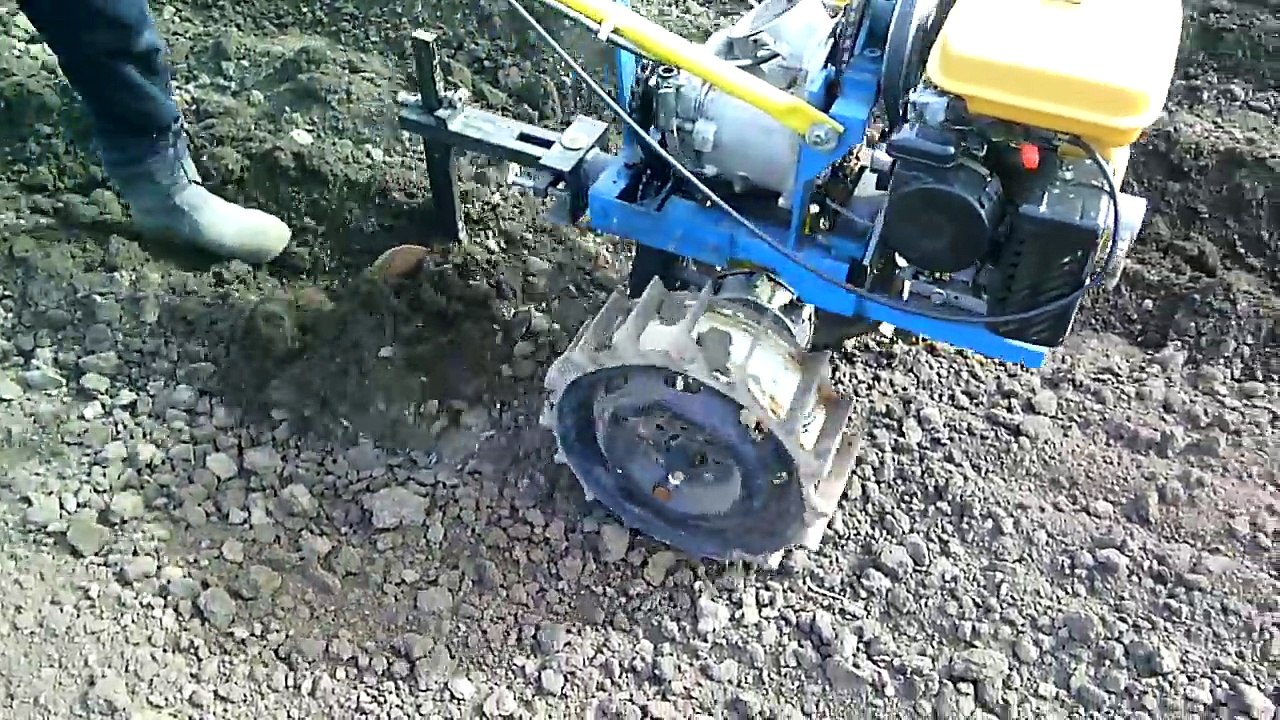 Homemade walk behind tractor. Plowing