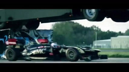 World record stunt- Giant truck jumps over speeding Lotus racing car
