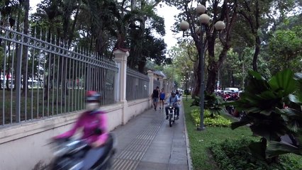 Motorbikes speed along the pavement at Saigon's major tourist sight
