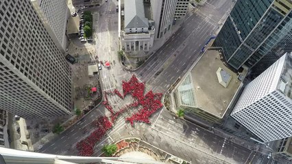 People form 'largest living maple leaf' for Canada celebration