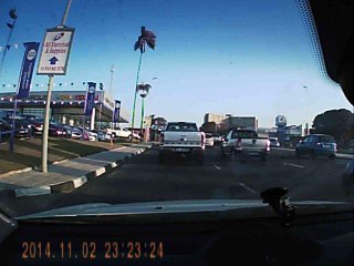 Car gets pushed off road by truck.