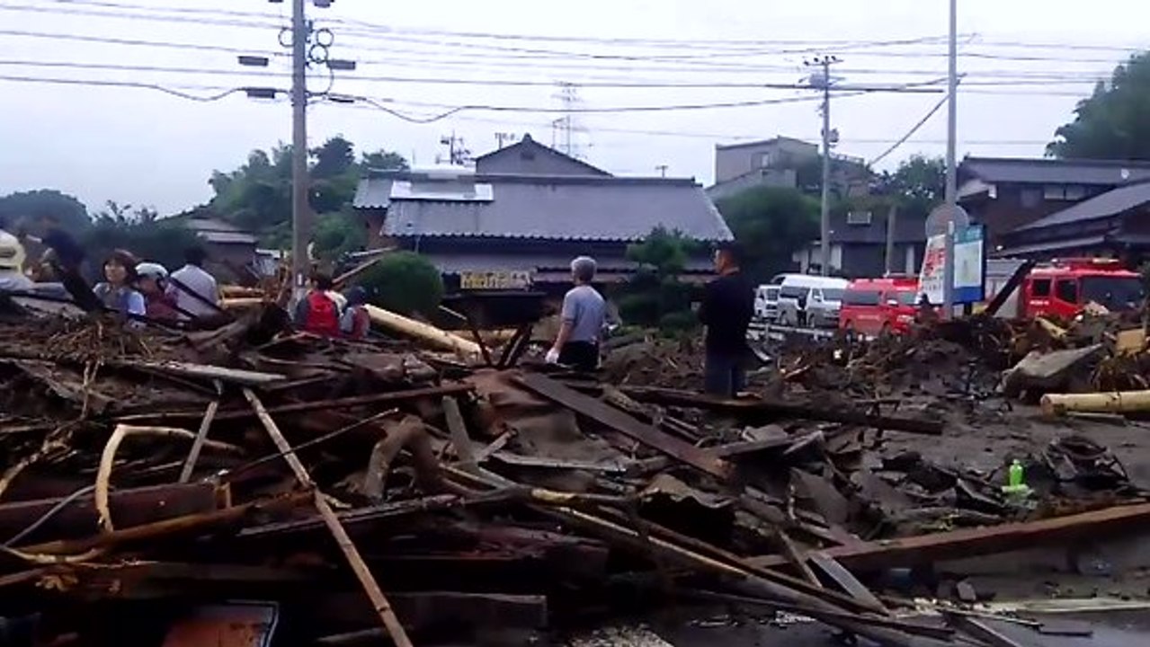 Tree Branches and Debris Strewn Across Asakura Streets Following Flooding