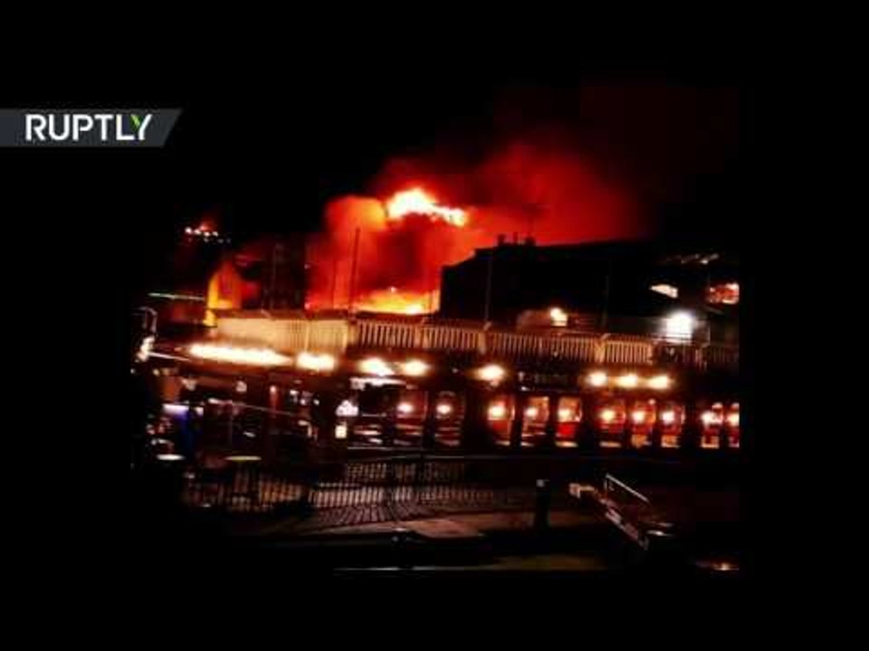 Flame fighters: Dozens of firemen try to bring blaze under control at Camden Lock market in London