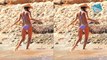 Alessandra Ambrosio shows off her toned figure in a skimpy purple bikini with rainbow streaks in her hair as she holidays in Ibiza