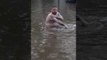 Man Takes a Bath in the Flooded Streets of Saskatoon