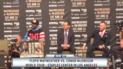 Floyd Mayweather Shows Off $100,000,000 Check In McGregor's Face