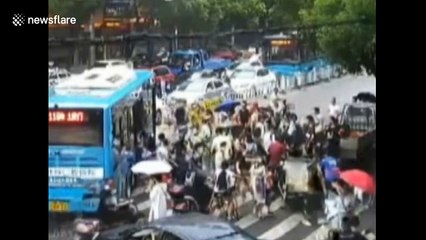 Good Samaritans lift up bus to rescue trapped woman