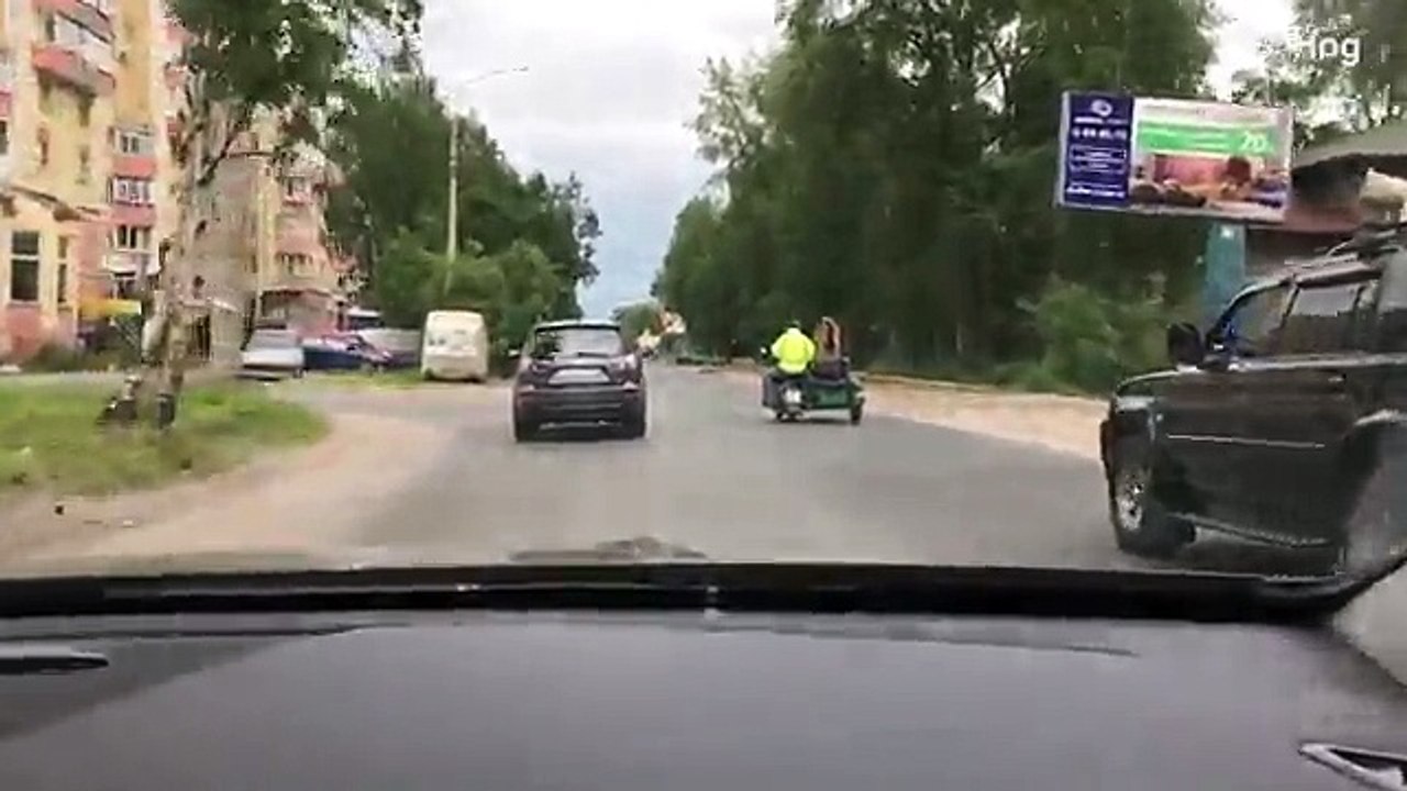 Giant bear rides shotgun on a motorcycle on Russian street