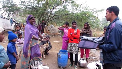 Slum-dweller in India shares food with street dogs