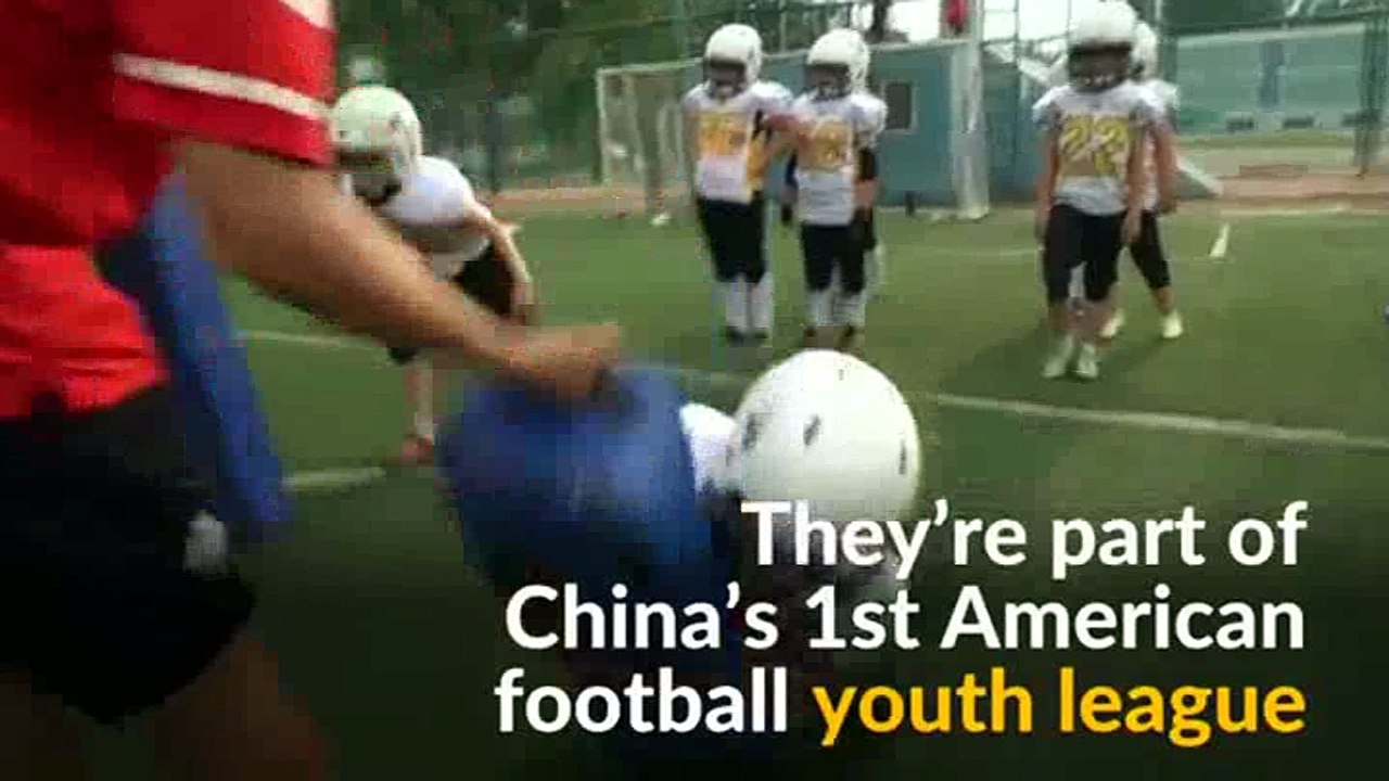Young Chinese tackle single child syndrome with American football