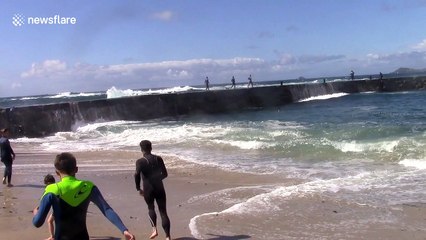 Heavy swells knock kids off pier in Cornwall