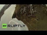 Russian daredevils brolly-hop from plane wing into Baikal ice-hole