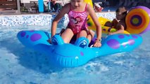 Kids playing in water pool with inflatable toys and shining toys. Funny video 2017
