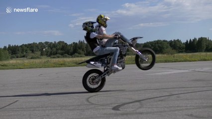 Motorcycle passenger hits the ground hard after wheelie landing