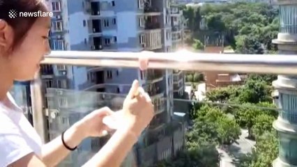 Girl tries to cook sliced meat on railing heated by the sun