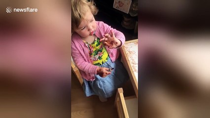 Little girl caught red-handed painting her 'nails' with a pen