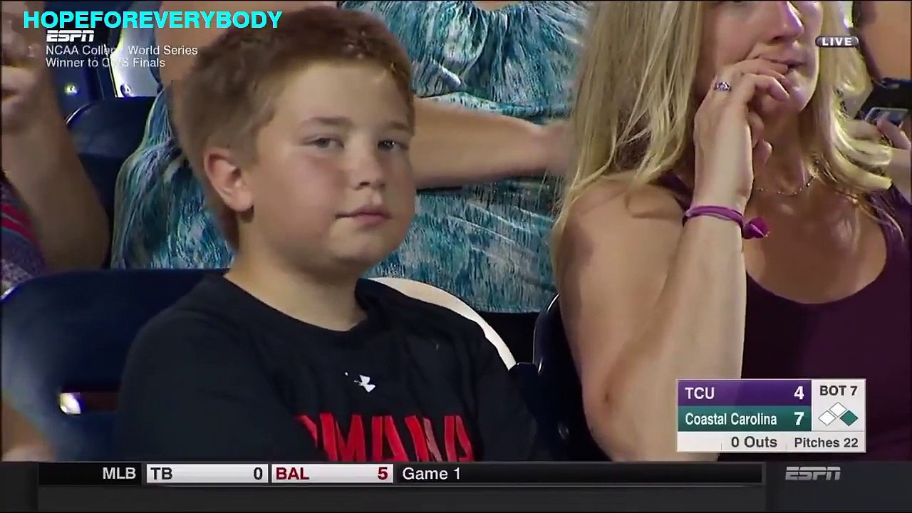 Kid works the camera during NCAA baseball game