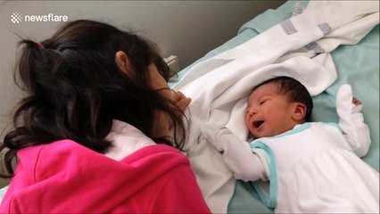 Sister meets her baby brother for the first time
