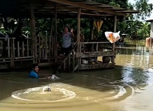 Relief Workers Throw Supplies to Locals Trapped by Floodwaters in Sakon Nakhon