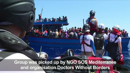 Eritrean migrants celebrate their rescue in the Mediterranean