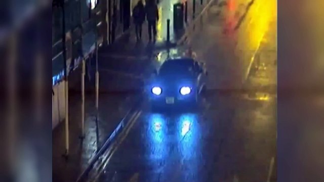 Man in wheelchair hitches a ride on the back of a car