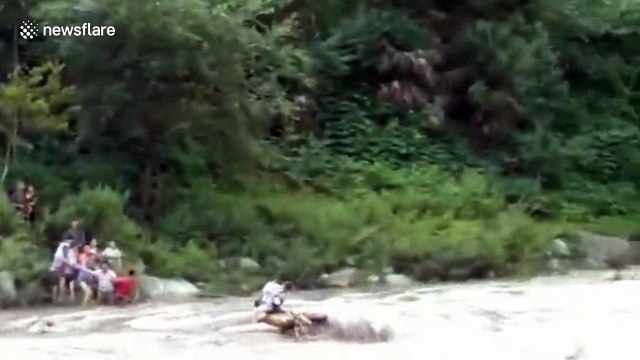 Rescuers save two tourists trapped in flooded river