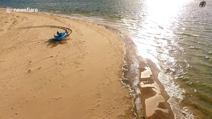Drone captures car rescue on beach as tide approaches